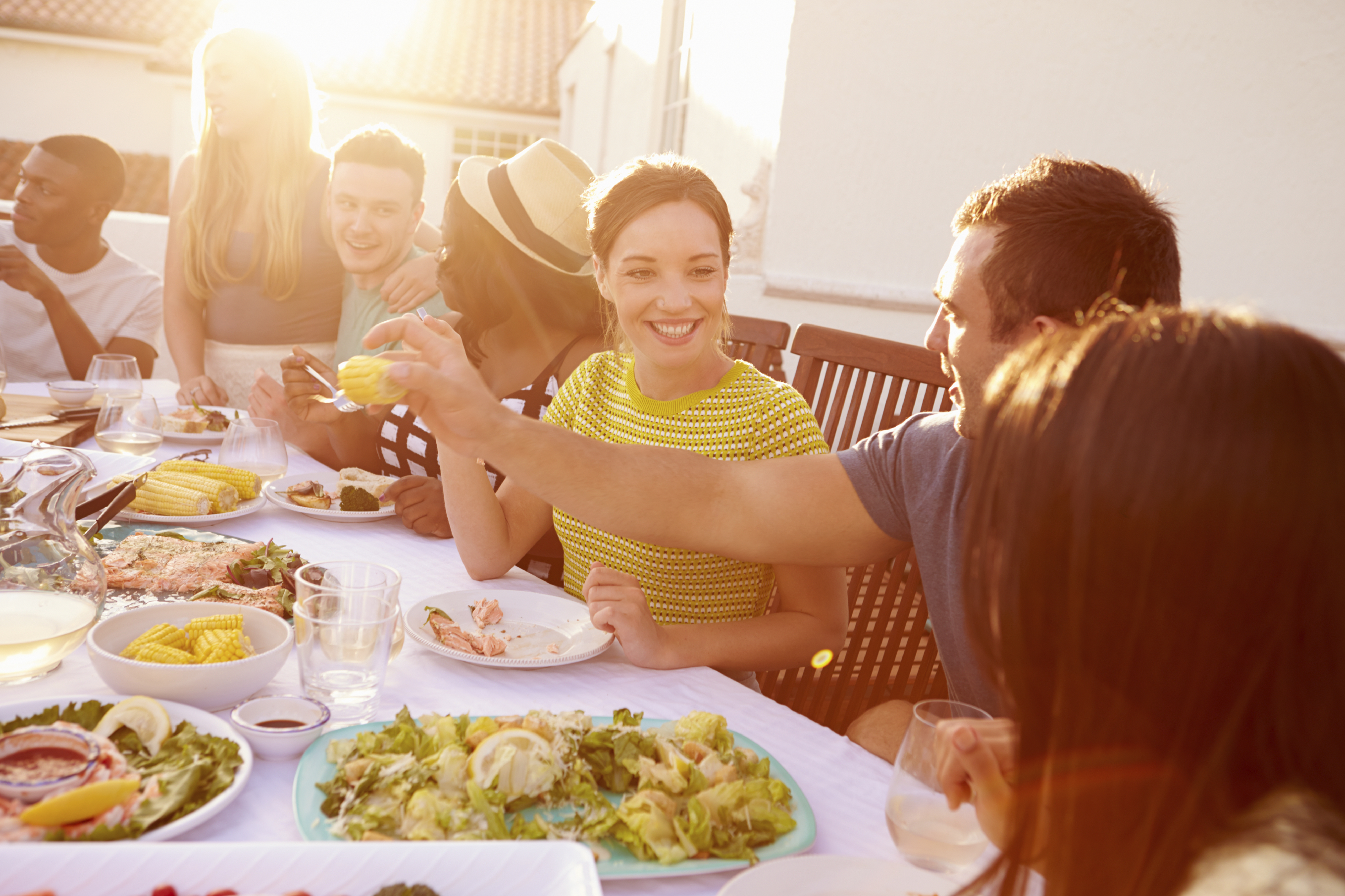 Couple Enjoying Outdoor Summer Meal With Friends